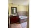 Bathroom featuring a vanity with sink and a jacuzzi style tub with tiled surround at 14810 Brahma Rd, Polk City, FL 33868