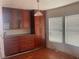 Dining room featuring wood floors, cabinets, and window with blinds for a light and airy space at 14810 Brahma Rd, Polk City, FL 33868
