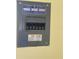 Close-up of a gray electrical panel mounted on a yellow wall with various breakers and hazard warnings at 14810 Brahma Rd, Polk City, FL 33868