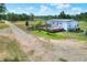Exterior of a charming home featuring a spacious wooden deck and well-maintained lawn at 14810 Brahma Rd, Polk City, FL 33868
