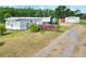 Single Gathering home with ramp access, storage sheds, ample parking, and expansive yard space at 14810 Brahma Rd, Polk City, FL 33868