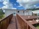 An exterior view of a house with a wooden ramp and deck at 14810 Brahma Rd, Polk City, FL 33868
