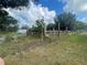 An exterior shot of a dilapidated fence and grassy lot at 14810 Brahma Rd, Polk City, FL 33868