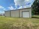 Garage exterior with large sliding door at 14810 Brahma Rd, Polk City, FL 33868