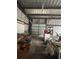 Interior of the garage showing a garage door and room for a workshop at 14810 Brahma Rd, Polk City, FL 33868