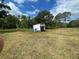 Acreage featuring a structure that appears to be for washing a car or some other cleaning at 14810 Brahma Rd, Polk City, FL 33868