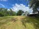 Expansive acreage with mature trees and a storage building, perfect for outdoor living at 14810 Brahma Rd, Polk City, FL 33868