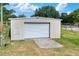 View of metal clad outbuilding, large roll up door, and concrete approach at 14810 Brahma Rd, Polk City, FL 33868