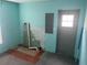 Unfinished blue room with a door and electrical panel, showing potential for customization at 14810 Brahma Rd, Polk City, FL 33868
