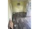 A room with wood-look floors, light yellow walls, and a door and two windows at 14810 Brahma Rd, Polk City, FL 33868