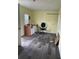 An interior view of a room with neutral yellow walls, a cabinet with white doors, and gray wood-look flooring at 14810 Brahma Rd, Polk City, FL 33868