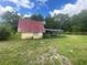 An exterior shot of a storage shed on a large grassy lot at 14810 Brahma Rd, Polk City, FL 33868