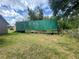 An exterior shot of a large green storage container in a lot with a cloudy sky at 14810 Brahma Rd, Polk City, FL 33868