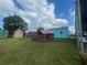 An exterior shot showcasing colorful yard sheds under a cloudy sky at 14810 Brahma Rd, Polk City, FL 33868