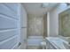 The bathroom features a white vanity and a tiled tub/shower combination at 1517 Leamington Ln, Winter Haven, FL 33884