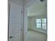A bright, carpeted bedroom is seen through an open door at 1517 Leamington Ln, Winter Haven, FL 33884