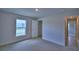 Bright bedroom with carpeting, window, and access to a closet and the hallway at 1517 Leamington Ln, Winter Haven, FL 33884