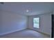 The carpeted bedroom has a window and neutral walls at 1517 Leamington Ln, Winter Haven, FL 33884