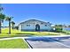 A modern clubhouse with well-manicured landscaping, clear blue sky and spacious sidewalks at 1517 Leamington Ln, Winter Haven, FL 33884