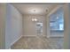 Open dining area with tile flooring, neutral walls, and a view into the bright kitchen at 1517 Leamington Ln, Winter Haven, FL 33884