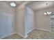 Home entryway featuring neutral walls, ceramic tile floors, and decorative lighting at 1517 Leamington Ln, Winter Haven, FL 33884