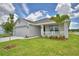 Lovely single-story home with attached garage, a cozy front porch, and well-maintained landscaping at 1517 Leamington Ln, Winter Haven, FL 33884
