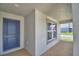 Charming front porch with a blue front door and neutral trim at 1517 Leamington Ln, Winter Haven, FL 33884