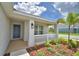 Inviting front porch with white railing, blue door, and manicured landscaping at 1517 Leamington Ln, Winter Haven, FL 33884