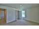A spacious main bedroom includes an open closet and a window for natural light at 1517 Leamington Ln, Winter Haven, FL 33884