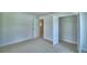 A large main bedroom with carpet has an open closet at 1517 Leamington Ln, Winter Haven, FL 33884