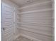 A walk-in pantry with multiple wire shelves offers lots of storage space at 1517 Leamington Ln, Winter Haven, FL 33884