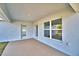 Covered patio with stucco walls, concrete floors, recessed lighting and view to the backyard at 1517 Leamington Ln, Winter Haven, FL 33884