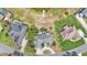 Aerial view of home near a lake, with neighboring houses and lush landscaping at 1854 Sherwood Lakes Blvd, Lakeland, FL 33809