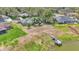 Aerial view featuring the home's backyard with lake access and nearby dock at 1854 Sherwood Lakes Blvd, Lakeland, FL 33809