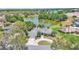 Scenic aerial shot showcasing the home's landscaping and proximity to a tranquil lake at 1854 Sherwood Lakes Blvd, Lakeland, FL 33809
