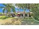 Expansive backyard with a patio set, grill, and manicured lawn, perfect for outdoor living and entertaining at 1854 Sherwood Lakes Blvd, Lakeland, FL 33809