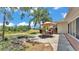 Backyard features a patio with outdoor dining set and a fire pit next to a lake at 1854 Sherwood Lakes Blvd, Lakeland, FL 33809