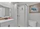 Well-lit bathroom featuring a glass enclosed shower, modern sink and a toilet at 1854 Sherwood Lakes Blvd, Lakeland, FL 33809