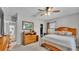 Bedroom with wooden furniture, ceiling fan and ensuite wardrobe at 1854 Sherwood Lakes Blvd, Lakeland, FL 33809