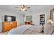 Bedroom with wood furniture, including a dresser and nightstands, has a ceiling fan at 1854 Sherwood Lakes Blvd, Lakeland, FL 33809
