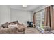 Cozy bedroom with a comfortable seating area, large window, and modern decor at 1854 Sherwood Lakes Blvd, Lakeland, FL 33809