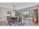 Dining room with sliding glass doors leading to a patio overlooking the lake at 1854 Sherwood Lakes Blvd, Lakeland, FL 33809