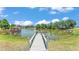 Picturesque view from the dock, highlighting the serene pond, gazebo, and lush surrounding greenery at 1854 Sherwood Lakes Blvd, Lakeland, FL 33809