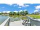 Relaxing chair on a private dock overlooking the calm lake, showcasing the tranquility of waterfront living at 1854 Sherwood Lakes Blvd, Lakeland, FL 33809