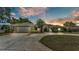 Charming single-story home featuring a well-manicured lawn and a circular driveway at 1854 Sherwood Lakes Blvd, Lakeland, FL 33809