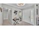 Inviting foyer featuring neutral tile flooring, a decorative light fixture and a white entry door at 1854 Sherwood Lakes Blvd, Lakeland, FL 33809