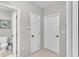 Hallway with two doors, a turtle wall hanging and a toilet area at 1854 Sherwood Lakes Blvd, Lakeland, FL 33809