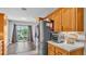Spacious kitchen with stainless steel refrigerator, oak cabinets, and tile flooring at 1854 Sherwood Lakes Blvd, Lakeland, FL 33809