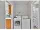 Functional laundry area featuring updated appliances and ample natural light and a doorway to a bathroom at 1854 Sherwood Lakes Blvd, Lakeland, FL 33809