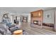 Cozy living area with a brick fireplace, wood floors, comfortable seating, and view to another living area at 1854 Sherwood Lakes Blvd, Lakeland, FL 33809